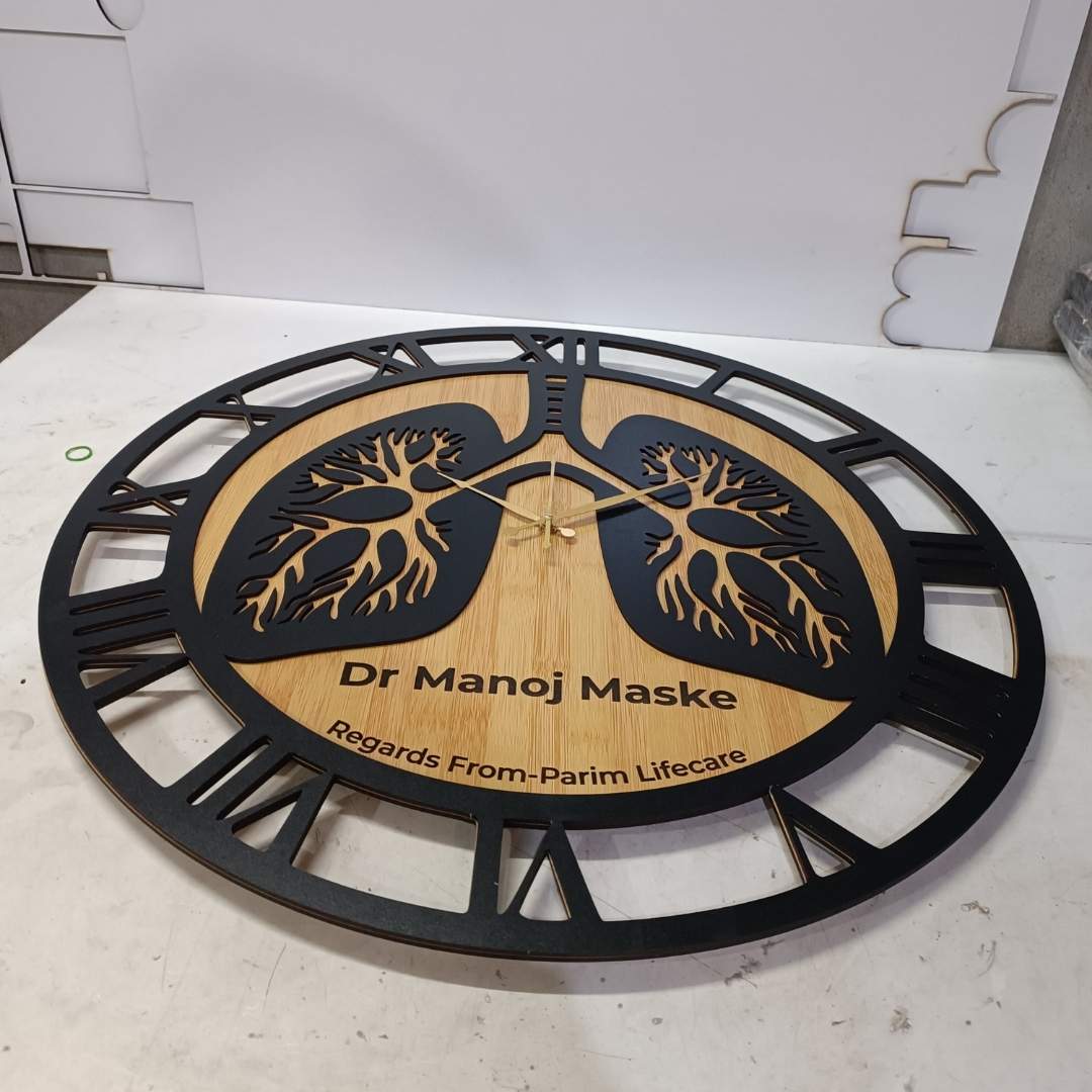 Decorative wall piece with tree design and text on a plain background