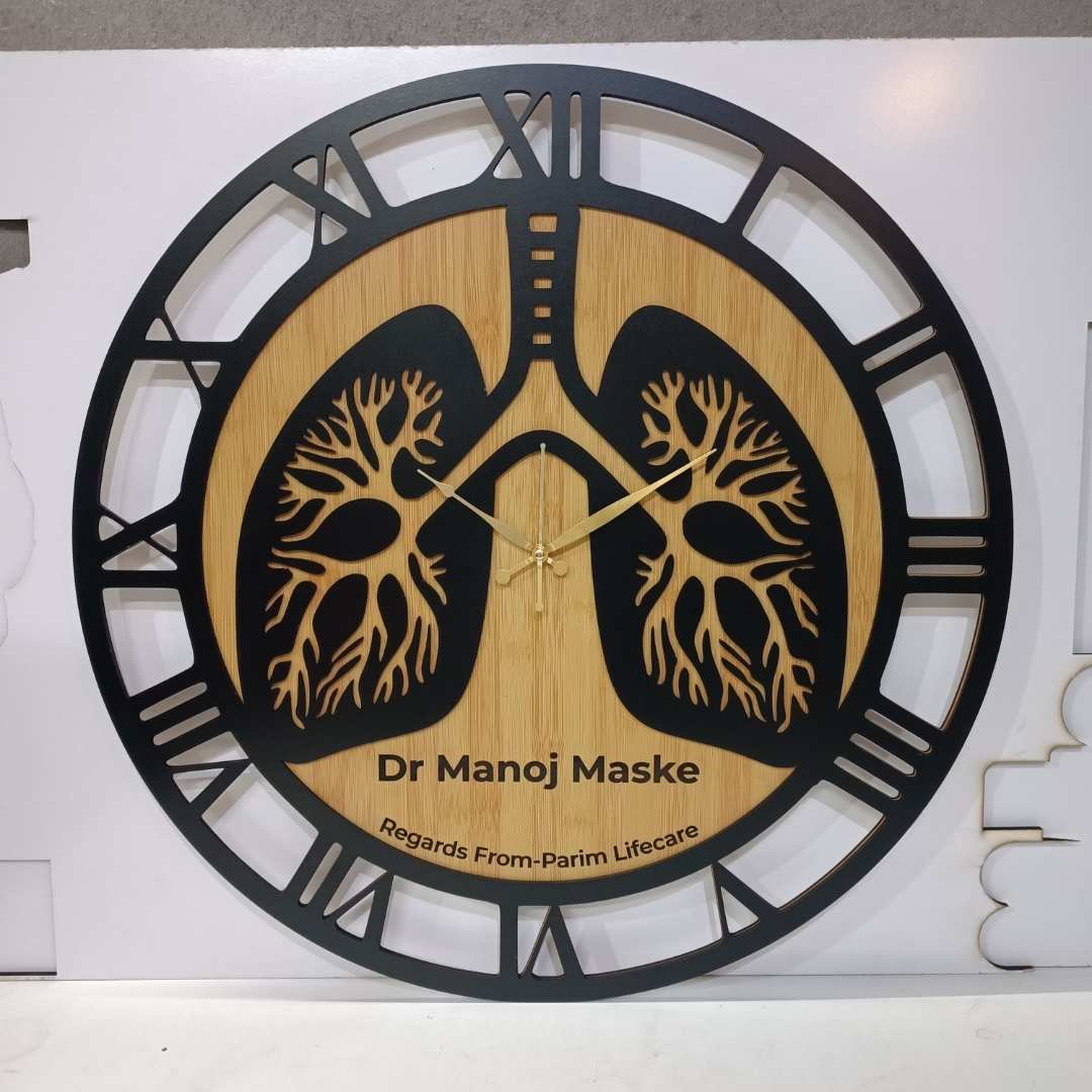 Wooden clock with lung design and engraved text on a white background