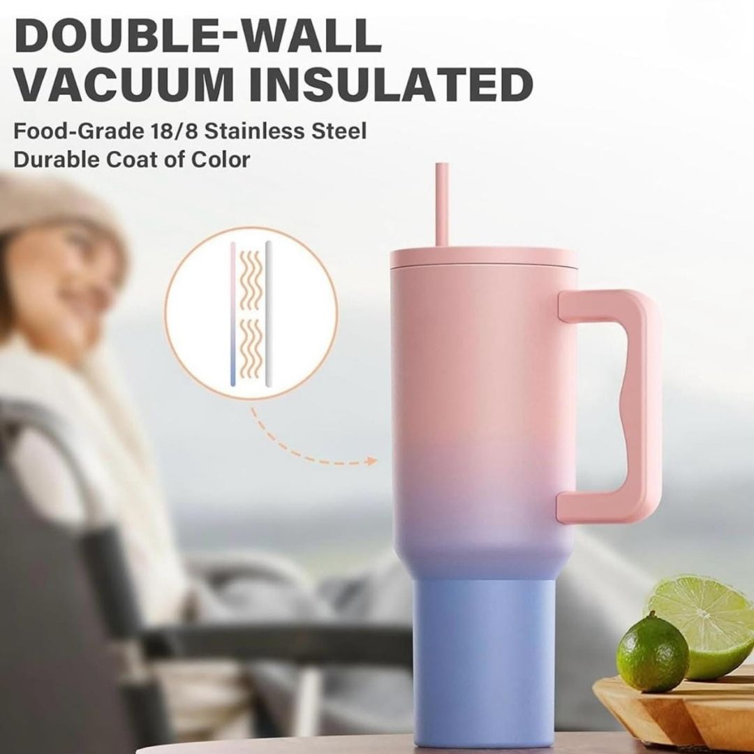 Double-wall vacuum insulated mug with gradient design, straw, and lime on a blurred background.