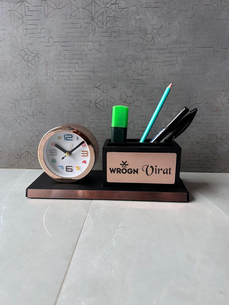 Desk organizer with clock and stationery items on a gray surface