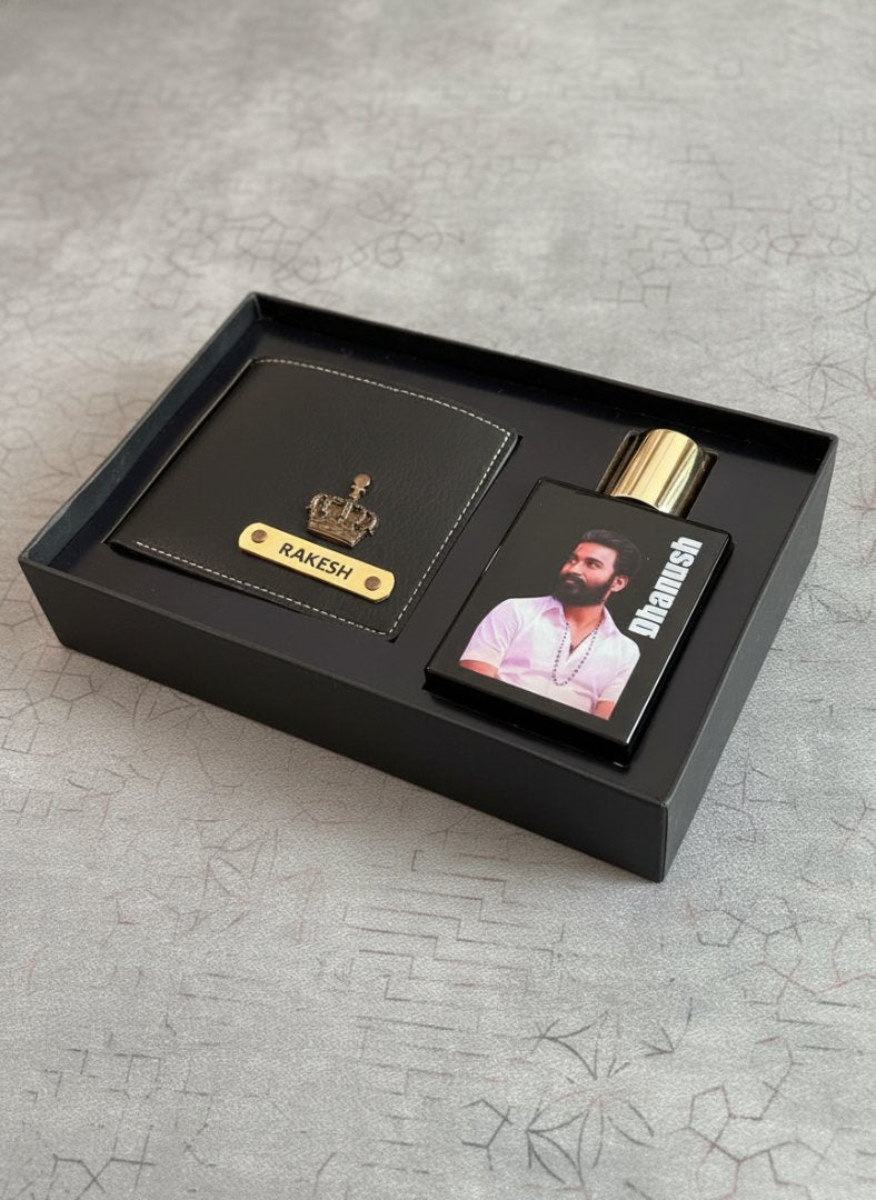Gift set with a black wallet and perfume bottle in a box on a textured gray surface