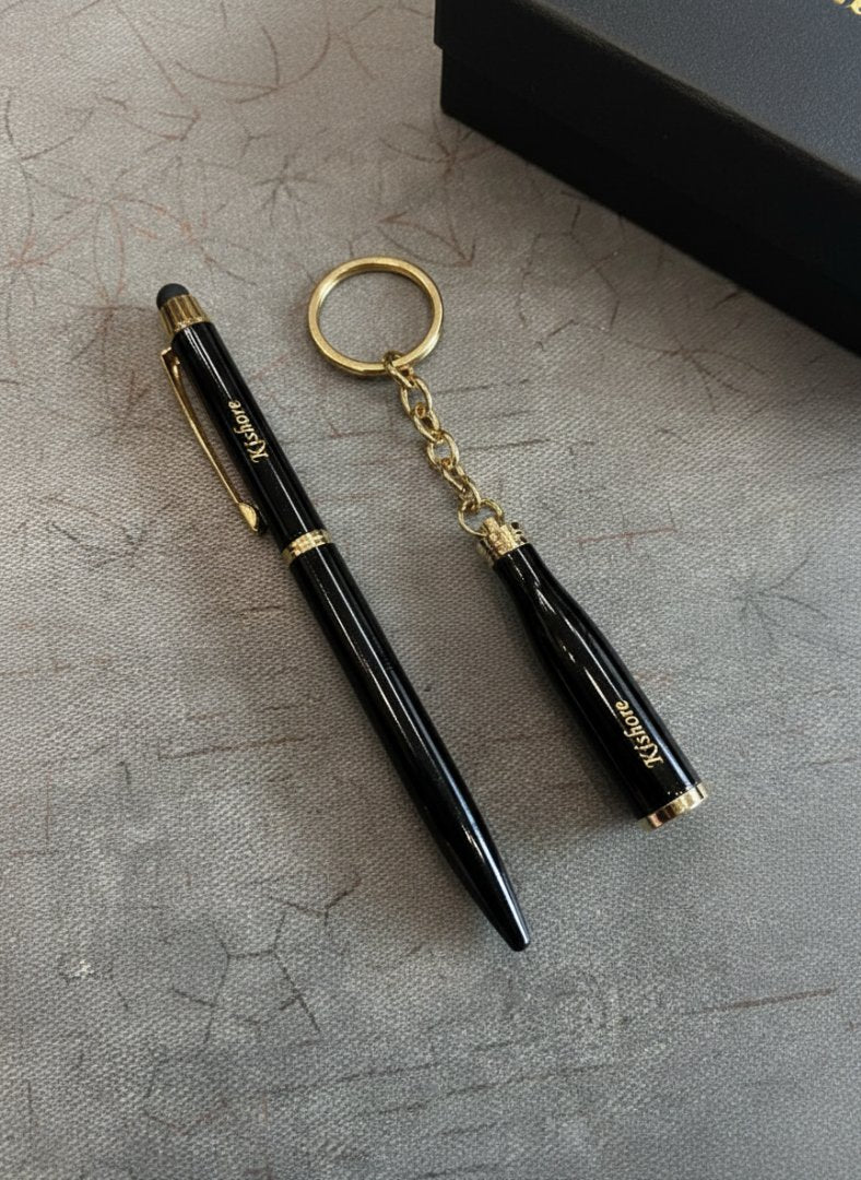 Black pen and keychain set on a textured surface