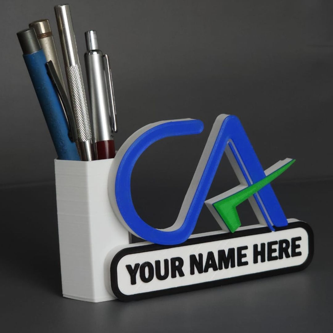 A personalized pen stand with the initials 'CA' in blue and a space for a name, holding pens and placed on a dark background.