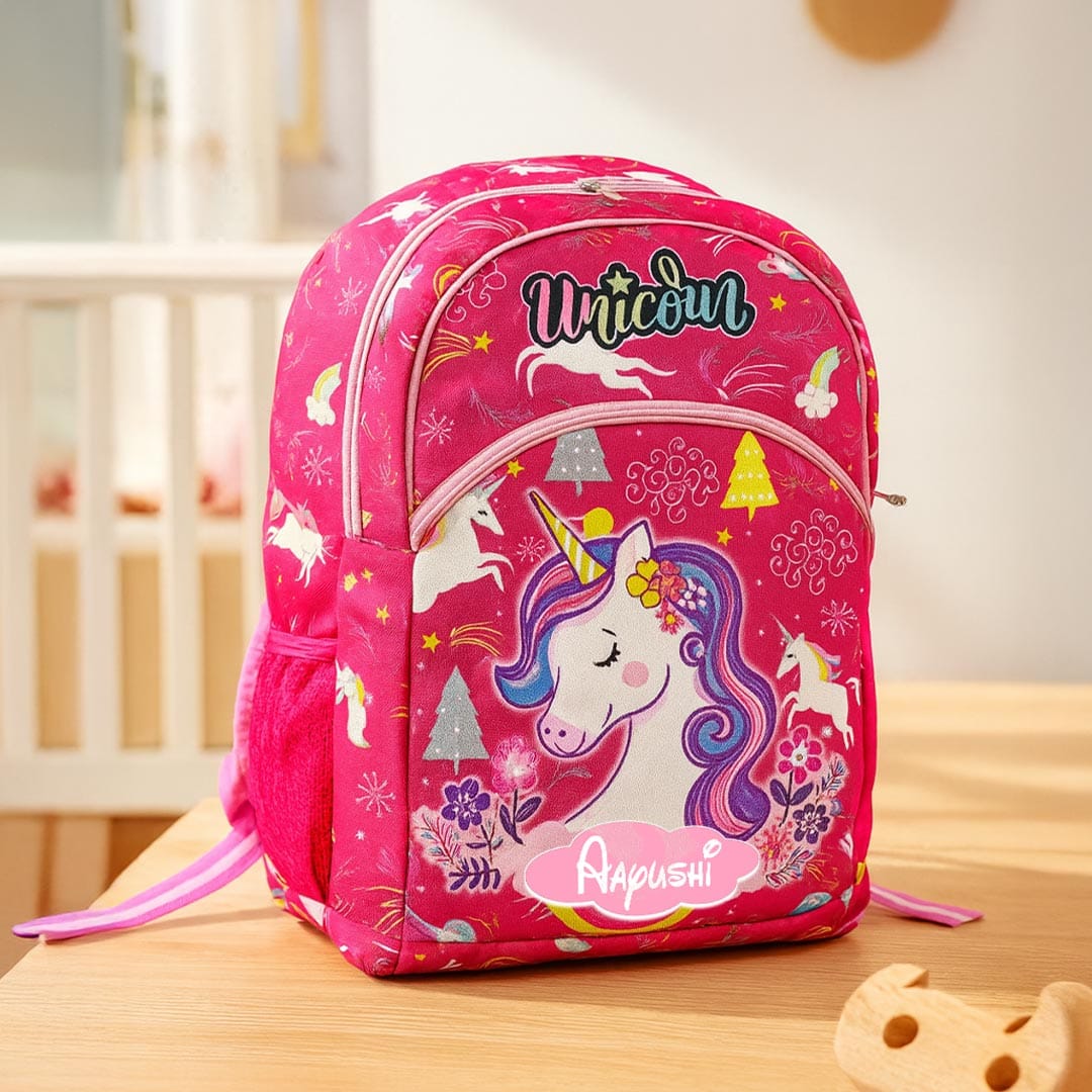 Pink backpack with unicorn design on a wooden surface