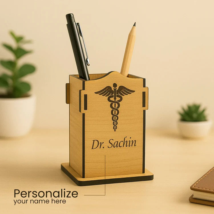 Wooden pen holder with personalized name on a desk with plants in the background