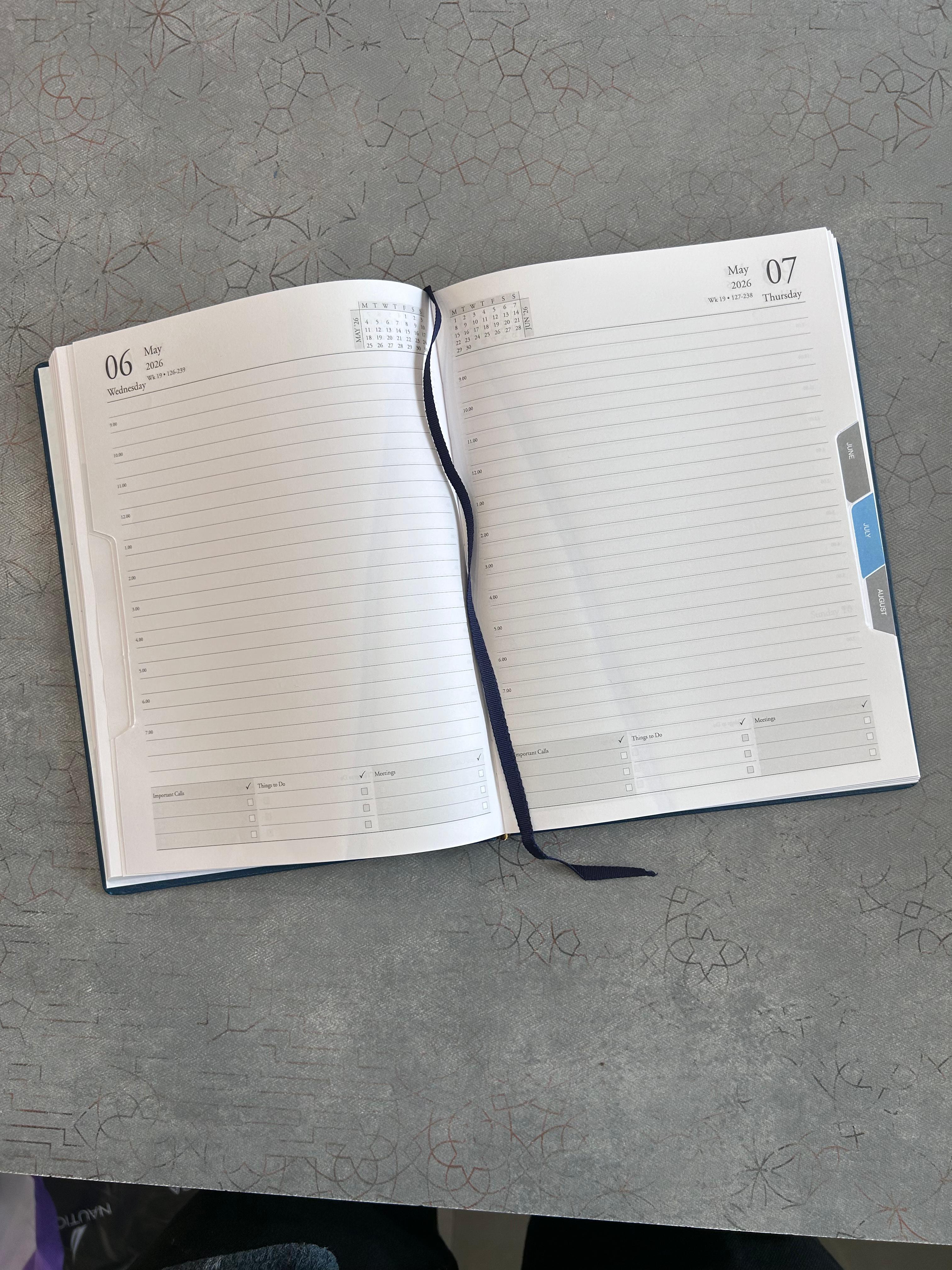 Open planner on a gray surface