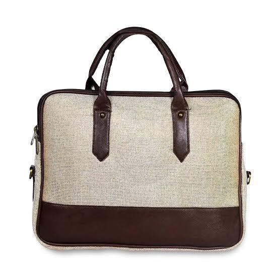 Beige and brown handbag with leather accents on a white background