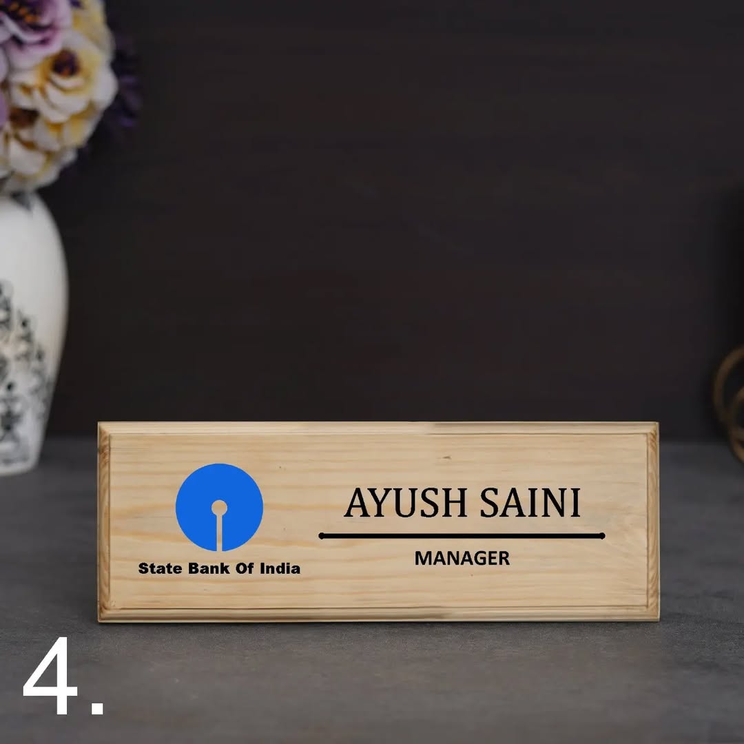 Wooden nameplate with engraved text and State Bank of India logo on a dark background