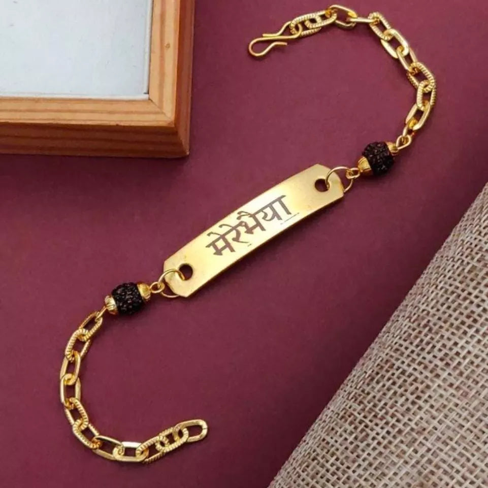 bracelet type chain rakhi with customize with your name it is in gold color, placed in red background