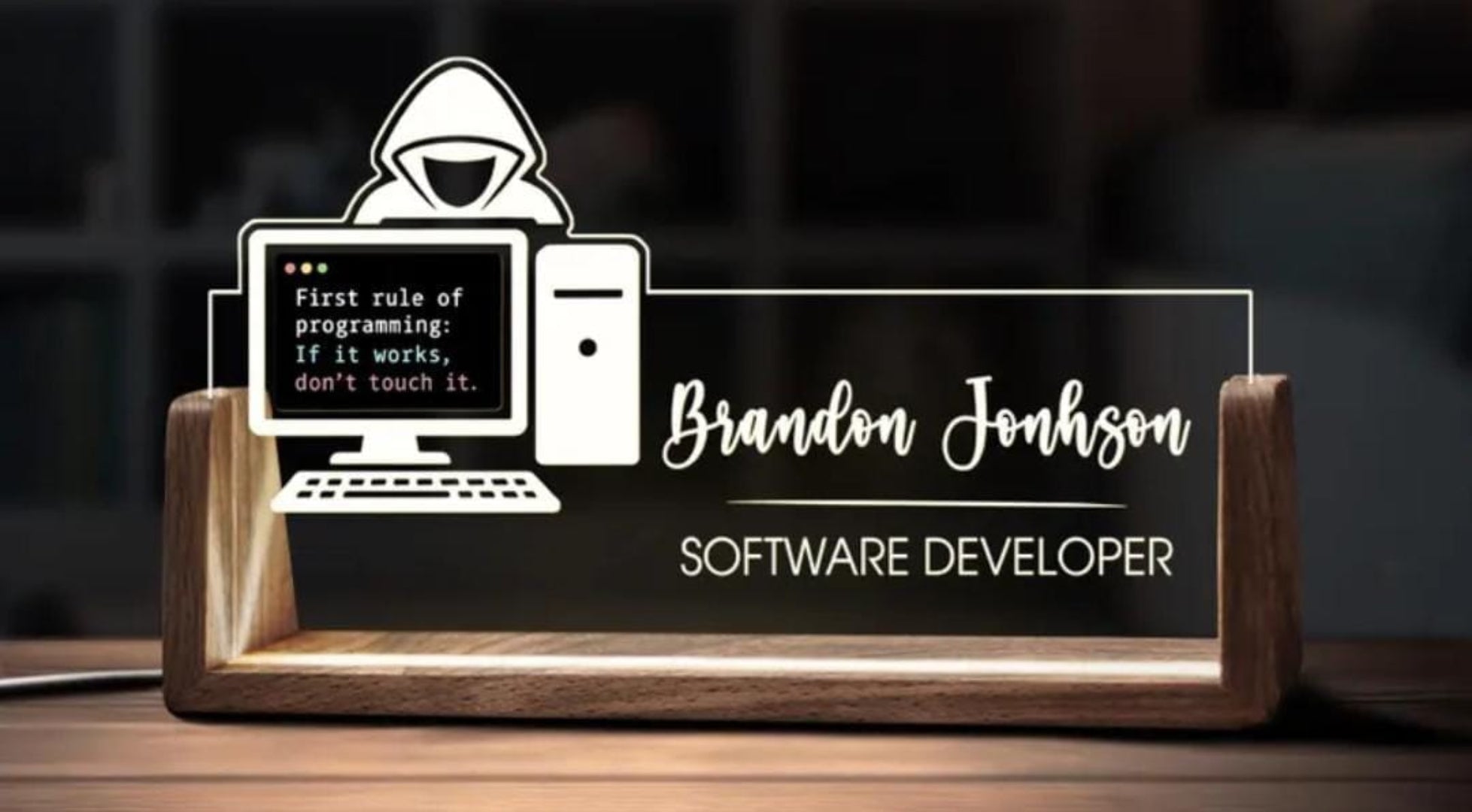 Personalized desk nameplate with computer illustration and text on a wooden stand.