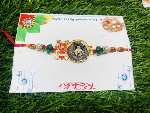 Mickey Mouse Rakhi For Kids mental rakhi with customized with photo and teddy sticker beside the photo ,on red thread green and white beed are there,