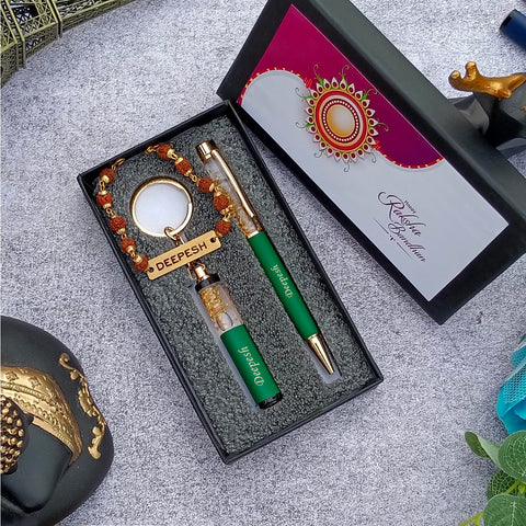 Brother gift combo in box there is one customized green pen and cutkey chain highquality rudraksh rakhi with name, beside box cap is there where greeting are written on it 