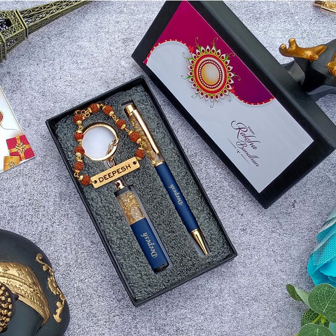 Brother gift combo in box there is one customized blue pen and cutkey chain highquality rudraksh rakhi with name, beside box cap is there where greeting are written on it 