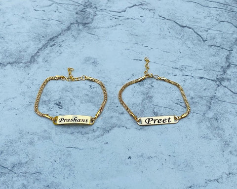 Bracelet rakhi with gold color with custom name ,  rakhi placed on floor,  size is adjustable 2 models available