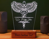 Orthopedic Surgeon Led Table Top,Customizable LED night light featuring a detailed caduceus symbol, personalized with the personalized name   and the any customized designation displayed on a wooden base with the option to add custom text at the bottom