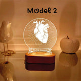 A heart-themed decorative lamp with an anatomical heart illustration, a heart rate line, and the custom text  displayed prominently. The lamp emits a warm glow from a wooden base, creating a cozy ambiance. The model number "Model -2" is written above the design.