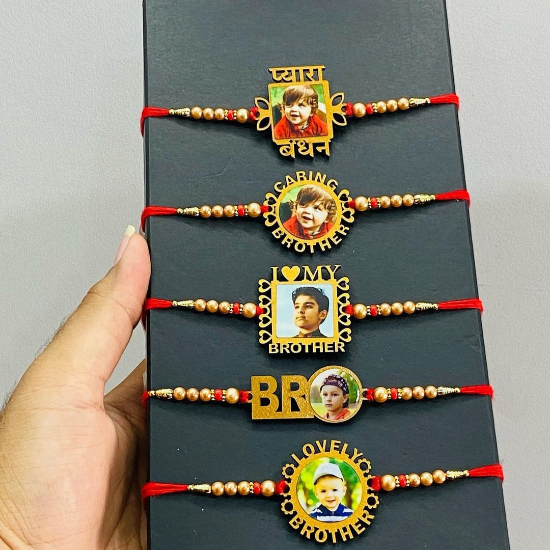 5 different type of customized photo rakhi's are tie to black box clearly shown there is customized option for own photo,plenty of beeds are add to rakhi thread