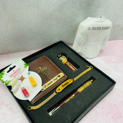 ther is customized oen and key chain and rakhi and wallet are place in gift presented box and beside there is penstand with customized name in model on apron coat, 4 small glass bottles are there with some material fillid in it