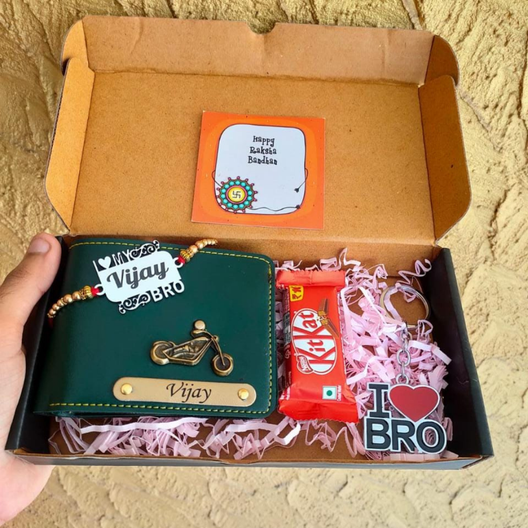 on brown box there is customized rakhi with name, oka premium look wallet with custom charm and custom name , kitkat chocolate is there, i love symbol and bro its written on one small plastic sticker