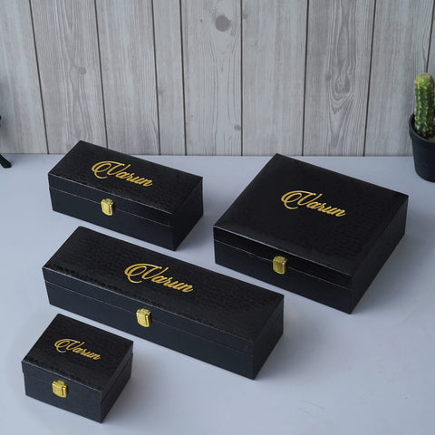 4 box are customized with name. all are in black with golden text