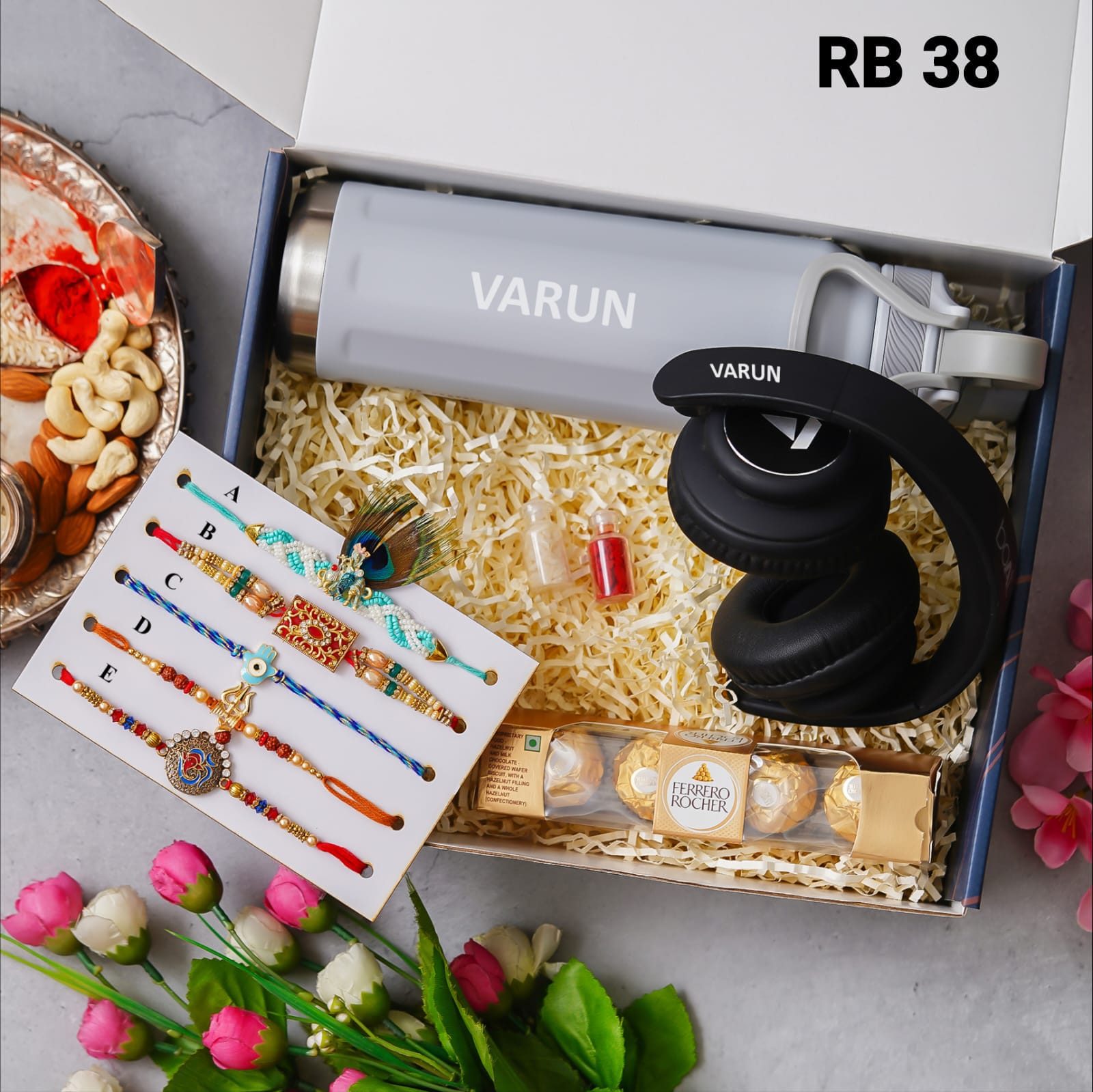 one blue color box is there and one head set with custom name and 5 models rakhi and one bottle with custom name one chocolate box and 2 small bottle glaas filled with chawal and roli