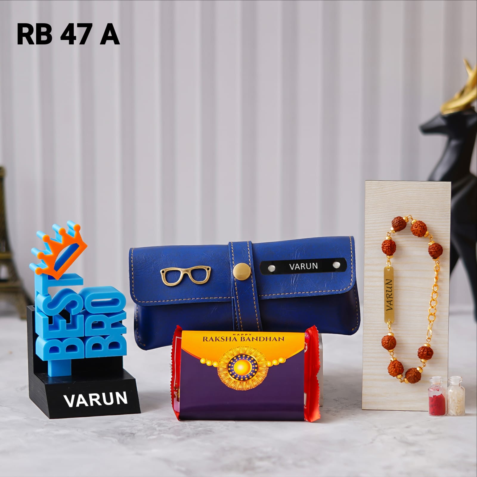 Best Bro 3D pen stand, personalized eyewear case with custom name and charm, Kit-Kat chocolate, Rakhi, and Roli Chawal. placed in floor background some flower vessale there