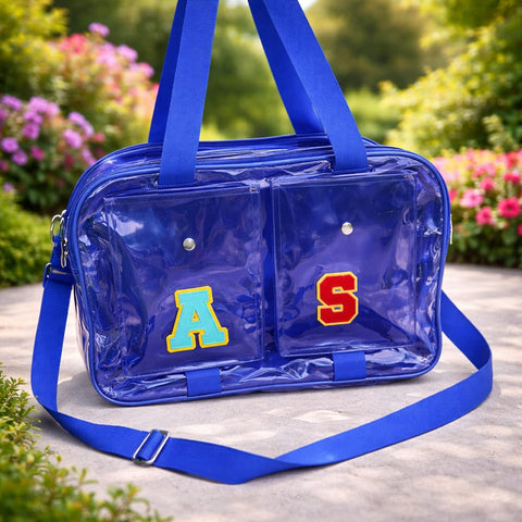 Clear blue bag with 'A' and 'S' initials on a blurred natural background