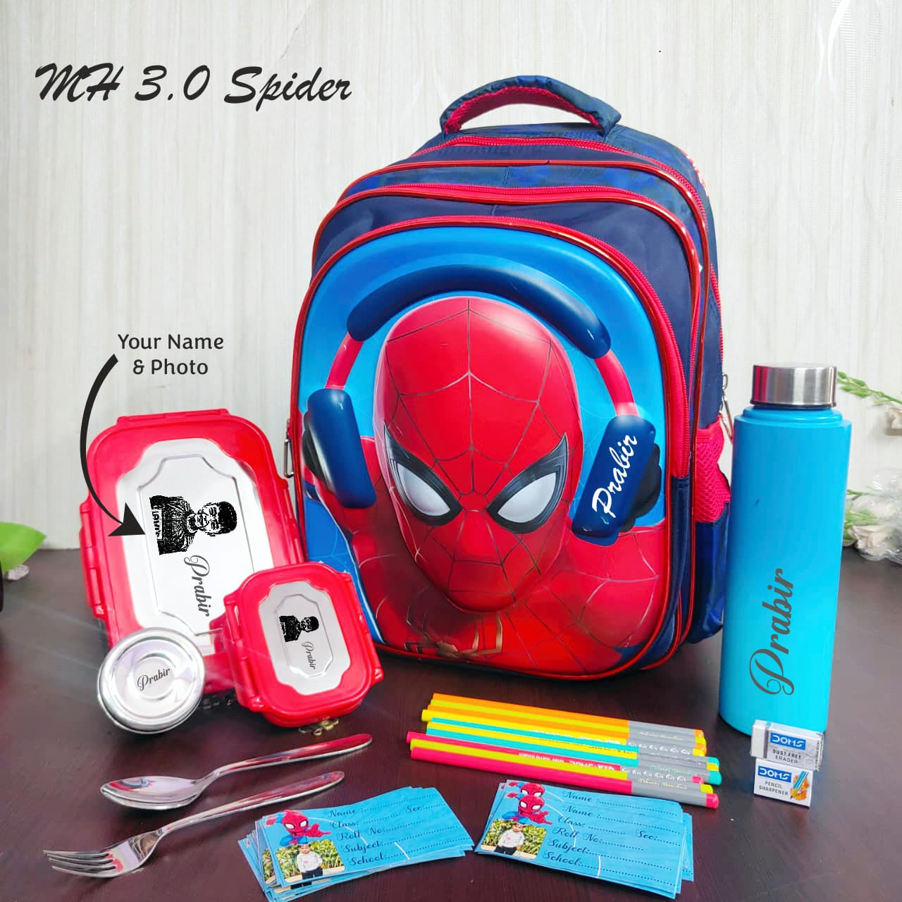 Spider-Man themed school backpack with stationery items on a wooden surface