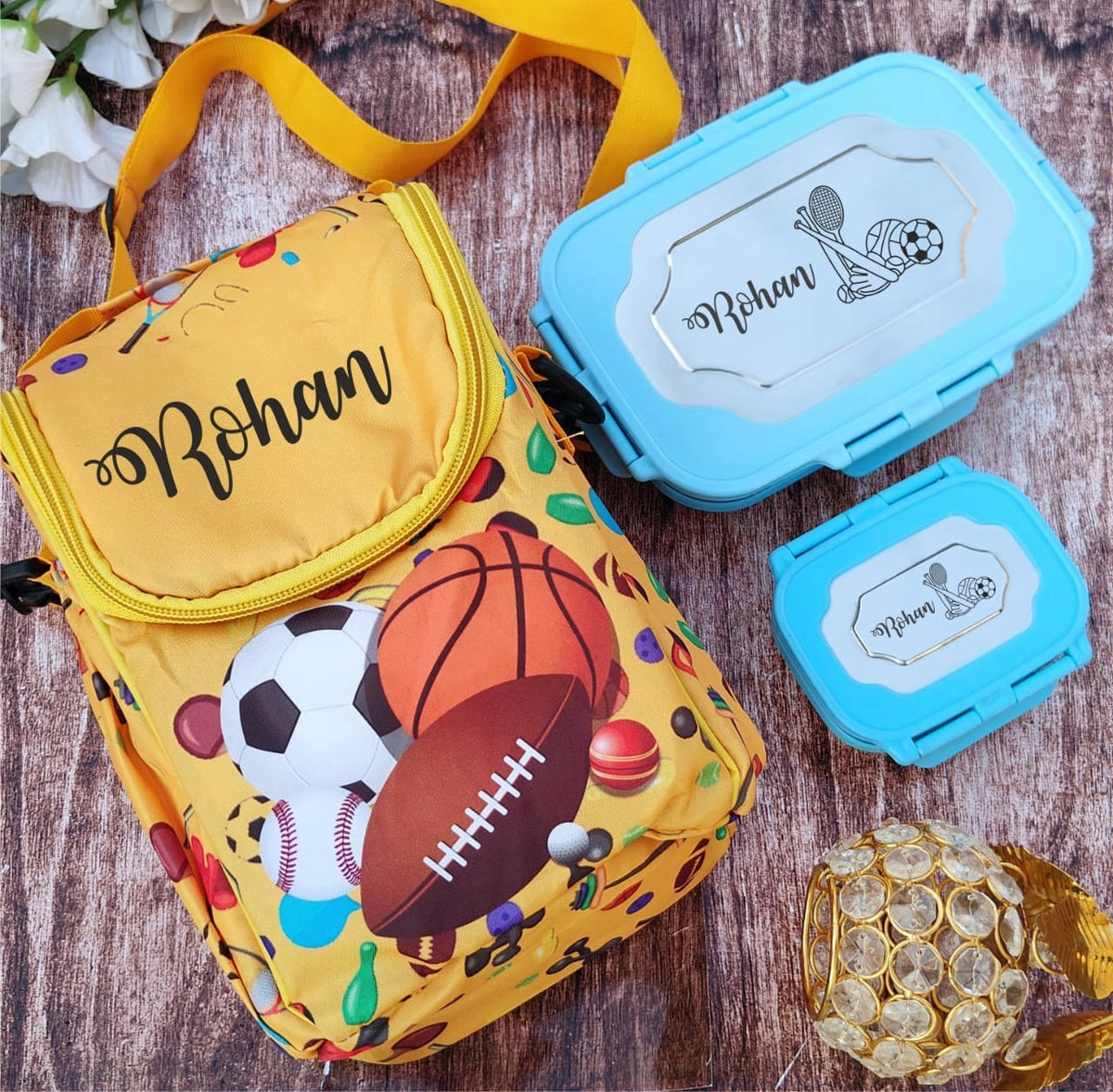 Yellow bag with sports-themed design and blue container on a wooden surface