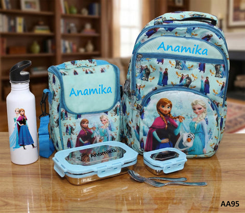 Frozen-themed backpack, lunch box, water bottle, and cutlery set on a wooden surface with 'Anamika' branding.
