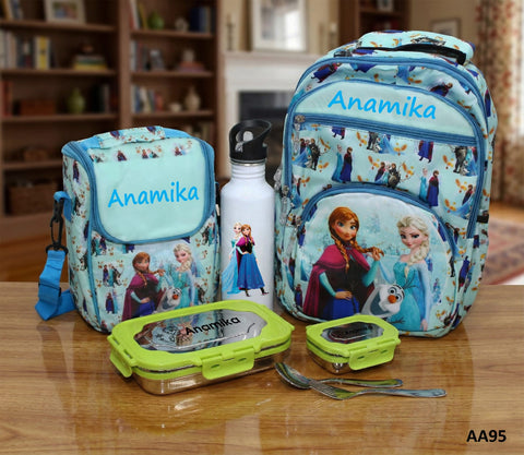 Children's backpack and lunch set with 'Anamika' branding on a wooden table.
