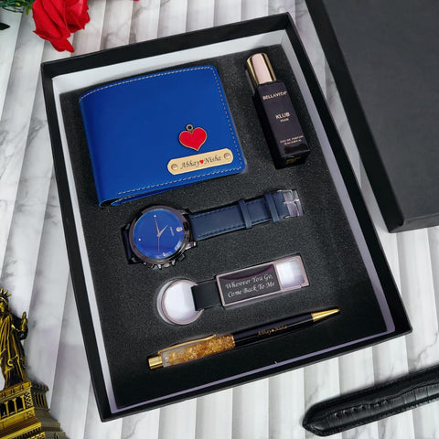 Gift set with blue wallet, watch, pen, and other items in a black box.