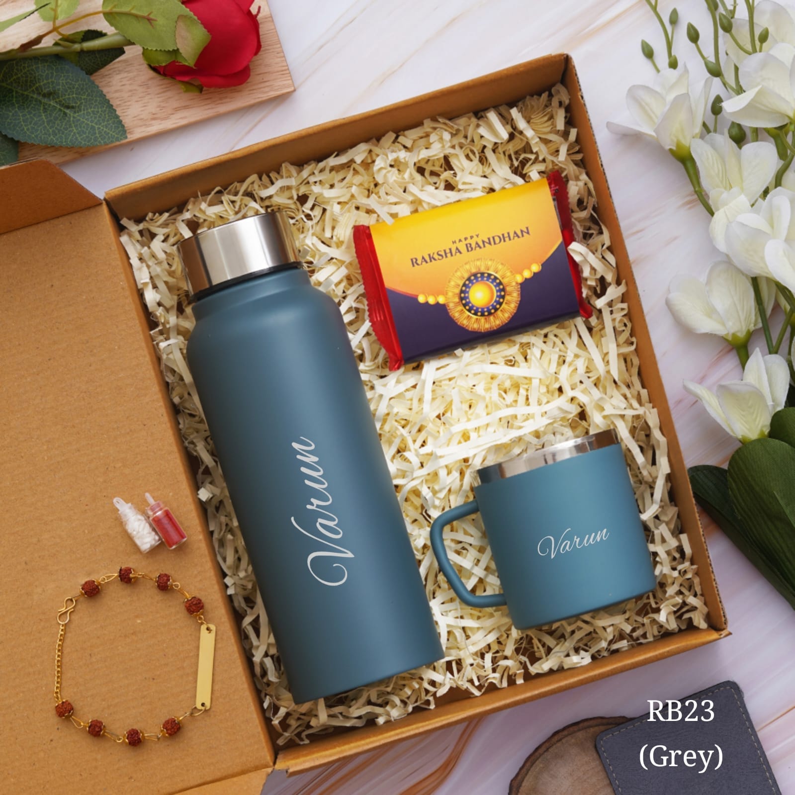 shown in picture there is one bottle and cup with name customization and rakhi also there with customization option , one chocolate is there, all are in one gift model box