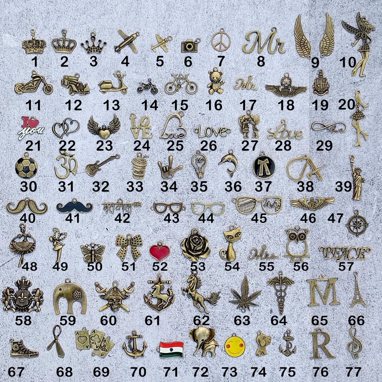 Collection of various small metal charms on a textured background