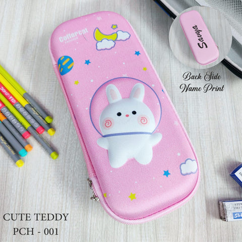 Pink pencil case with teddy bear design on a wooden surface with stationery items.
