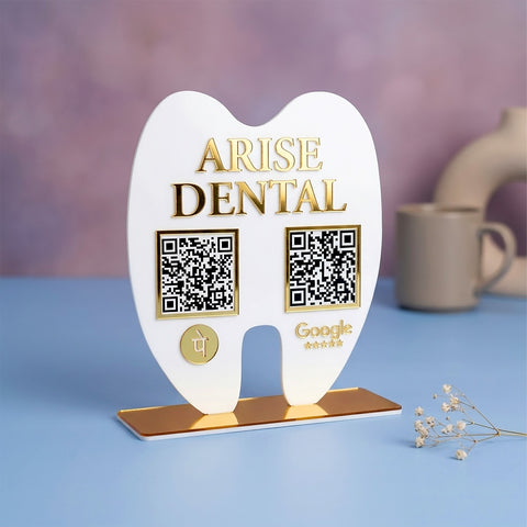 Heart-shaped stand with 'Arise Dental' branding and QR codes on a blue surface.