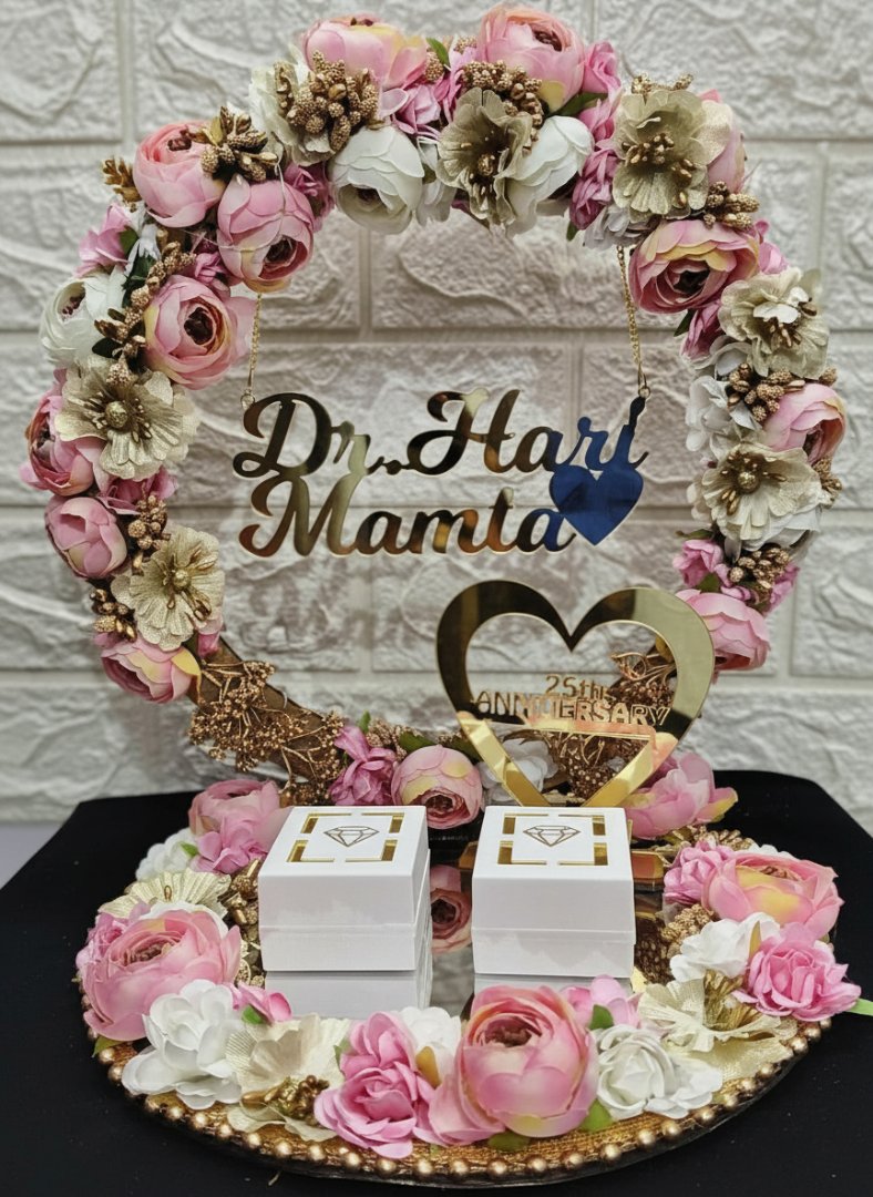 Decorative cake with flowers and 'Dr. Hart Mamta' text on a textured wall background