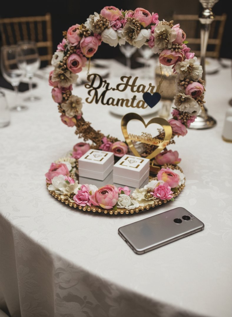 Decorative floral arrangement with 'Dr. Har Mamt' on a table with a phone.