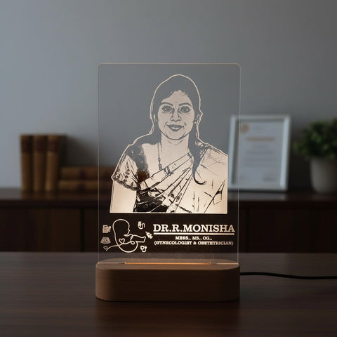 Acrylic desk lamp with a portrait of a woman and text on a wooden base.