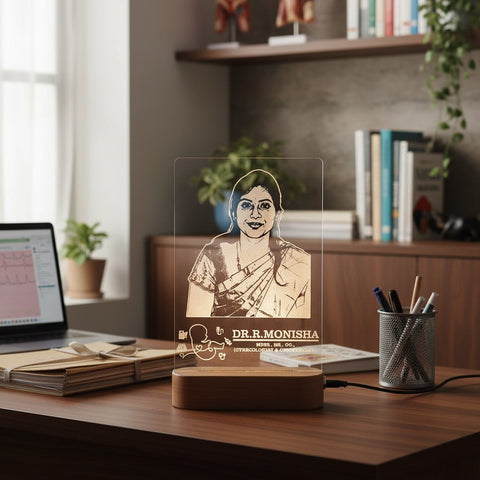 Desk setup with a personalized lamp featuring a portrait and name on a wooden desk.