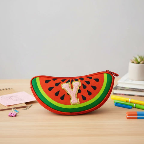 Watermelon-shaped pouch with letter 'Y' on a wooden surface