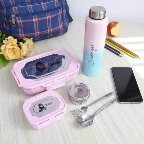 Pink lunch box, water bottle, and utensils with 'Savvy' branding on a table.