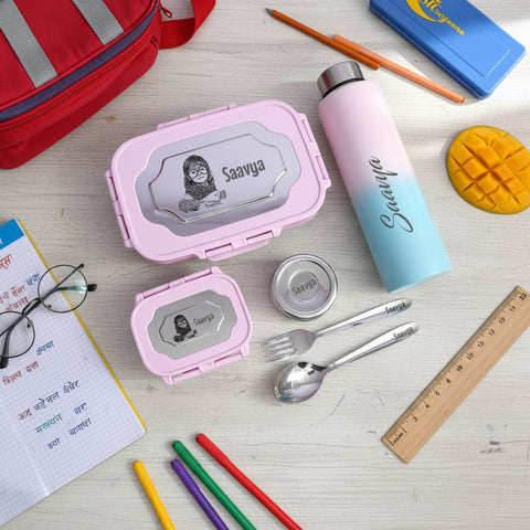 School supplies including pink lunch box, water bottle, and cutlery set on a wooden surface.