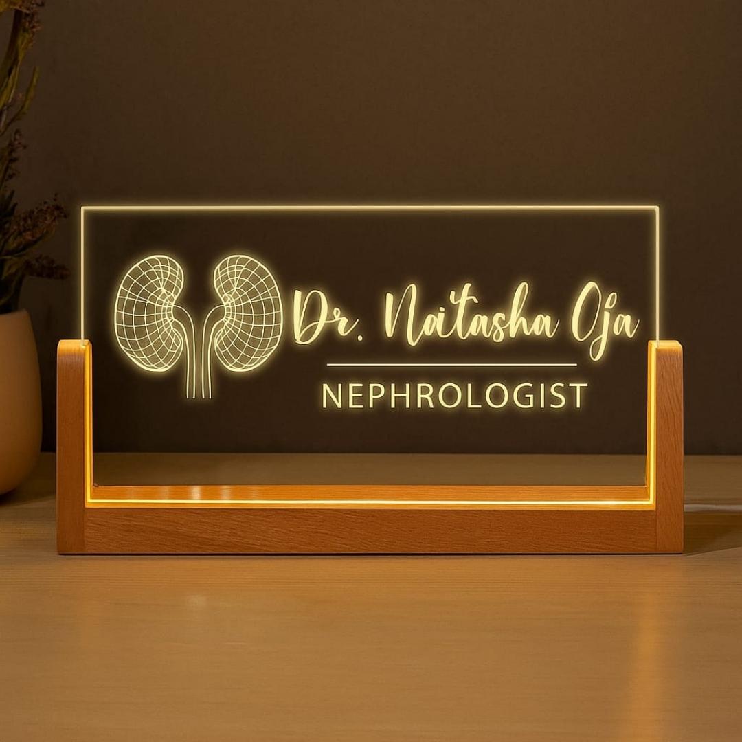 Neon sign with kidney symbol and text 'Dr. Naitasha Oja Nephrologist' on a wooden stand.