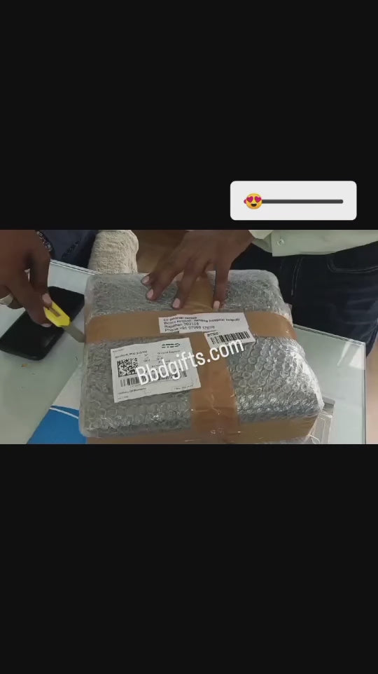 2 persons are opening the packed courier parcel while smiling, in black box it contains personalized mug with permanent name print and red heart shaped stethoscope,whatsup chat is there at end of the video,customer sent messages like best gift for doctors, really very happy ,some read heart and flower lovely emojies,wesite is bbdgifts.com