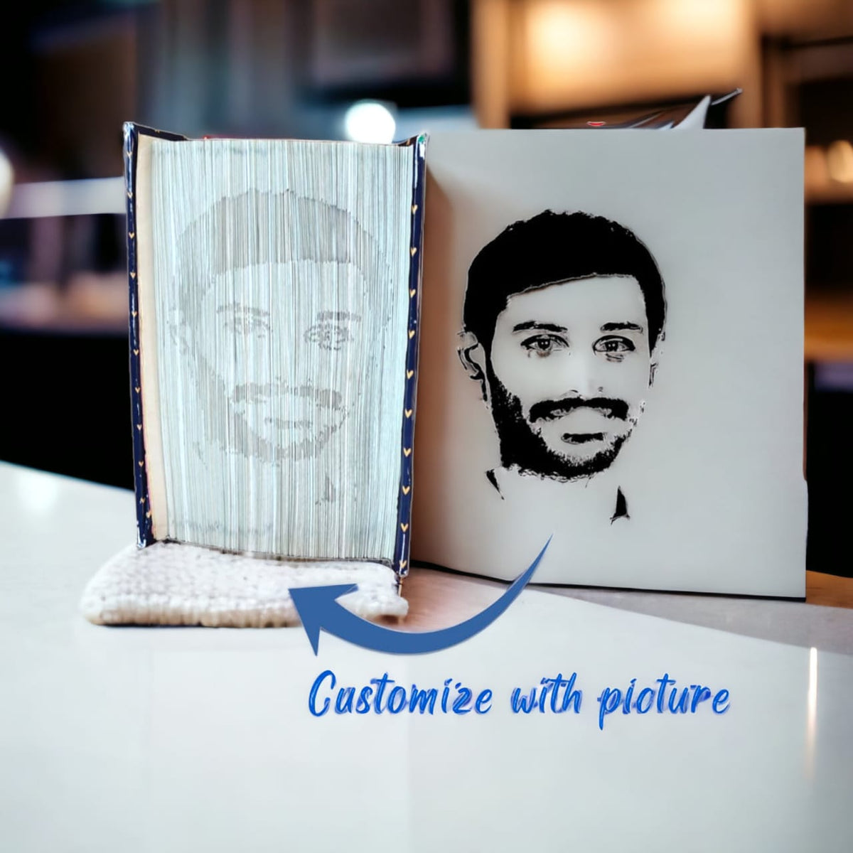 Handmade custom folded book art featuring a personalized portrait shadow design. Each piece is crafted by intricately folding book pages to create a unique, three-dimensional portrait. Ideal as a thoughtful and artistic gift for special occasions.book is placed on white table in room.