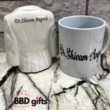 white colored ceramic apron penstand and mug with fully personalized , palced on marbel floor