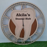 A stylish wall clock designed for a dental office, featuring a large wooden tooth at the center. The clock has an elegant Roman numeral frame and the CUSTOM text displayed prominently on the tooth. The clock is placed on green floor front of white wal