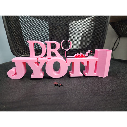 Customized Doctor Pen Stand With custom Name, where stethoscope is placed beside the name. placed on chair 